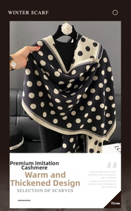 Close-up of thick winter scarf showing soft cashmere-like texture and beige polka dots