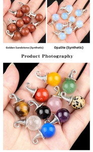 Macro shot of assorted gemstone crystal ball pendants with silver clips held by hand