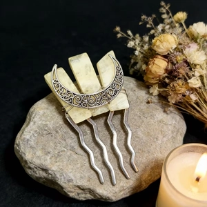 Detailed view of handmade moon hair comb with raw yellow crystals and silver metal wire
