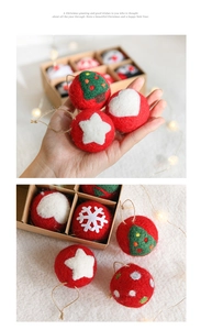Detail of red wool felt Christmas ornaments with snowflakes and trees in a gift box