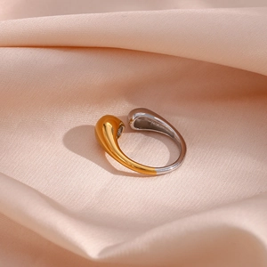 Two-tone stainless steel open ring with gold and silver teardrop ends on pink silk