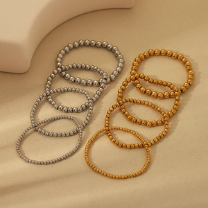 Detail of 18K gold and silver plated beaded elastic bracelets in various bead sizes