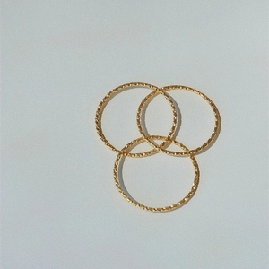 Three-piece set of gold textured titanium steel rings with starshine finish in a triangle layout