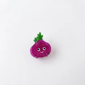 Purple onion fruit hair claw clip with smiling face and green leaves on white background