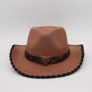 Close-up of brown wool felt cowboy hat with leather band and bronze leopard head emblem