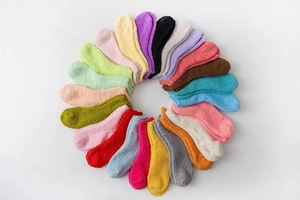 Detailed close-up of colorful plush coral fleece socks arranged in a circular pattern