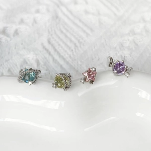 Macro shot of colorful star and butterfly earrings set with sparkling cubic zirconia