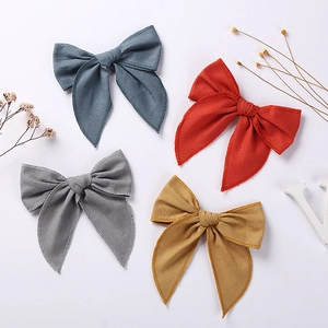Set of four linen cotton bow hair clips for girls in navy, orange, gray and yellow colors