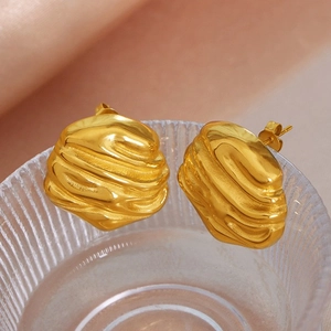 Detailed close-up of 18k gold plated earrings featuring a unique irregular rippled texture