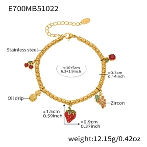 Detailed view of gold plated stainless steel bracelet with colorful fruit charms and zircons