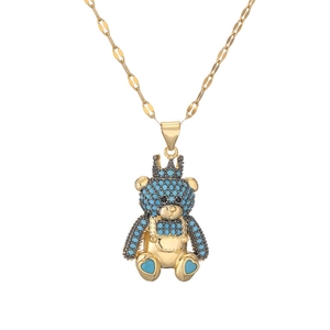 Charming gold teddy bear necklace with crown and sparkling blue crystal inlay