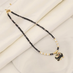 Natural stone beaded necklace with a colorful zircon elephant pendant on beige silk