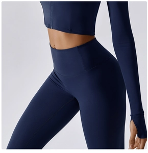 Detail of high-waist yoga leggings and thumbhole sleeves in navy blue athletic fabric