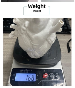 Macro shot showing the 168g weight of a white anatomical heart ceramic vase