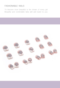 Detail of purple gradient press-on nails with white hand-painted hearts and 3D charms