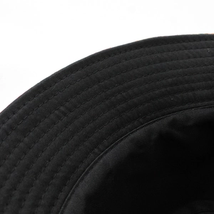 Close-up of a black cotton sun hat featuring reinforced parallel brim stitching details