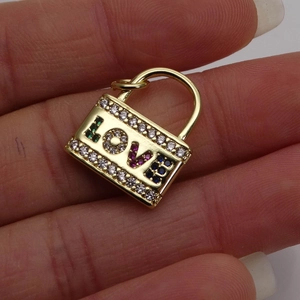 Golden eye-shaped lock pendant with micro-paved zircons and colorful LOVE lettering