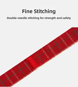 Detail of red plaid dog harness featuring durable nylon webbing and reinforced double stitching