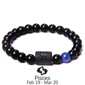 Detail of Pisces constellation bead bracelet with black obsidian and blue lapis lazuli