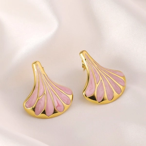 Detailed shot of fan-shaped pink enamel earrings with 18k gold plating on white silk