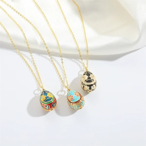 Exquisite Fabergé style enamel egg pendants in blue, pink and black on gold chains