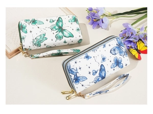 Close-up of double zipper wallets with butterfly prints and matching wrist straps