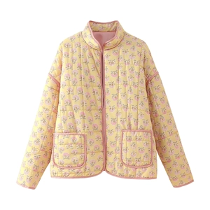 Detailed flat lay of a yellow quilted jacket with pink and purple floral patterns