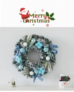 Detail of Christmas wreath with blue bows and faux snow pine needles decoration