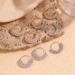 Detail view of 18K gold plated hoop earrings with pearls and crystals on stone
