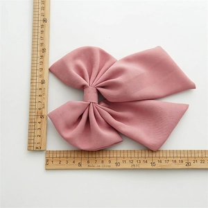 Elegant large pink fabric bow hair clip with spring fastener measuring 16x15cm size