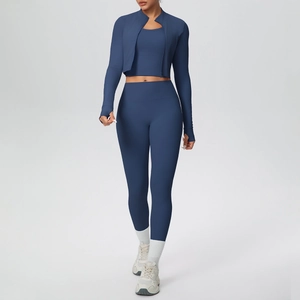 Detail of dark blue three-piece yoga set featuring zipper jacket with thumb holes