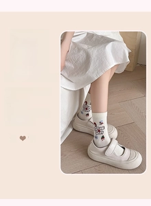 Gros plan sur chaussettes en coton blanc crème avec motif cartoon et texte Fortune