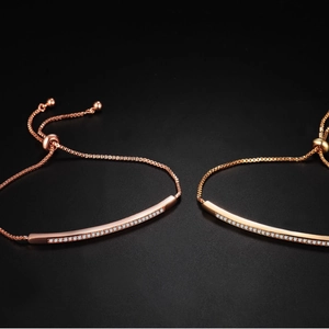 Adjustable rose gold bangle with a single row of sparkling zircons and sliding clasp
