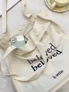 Minimalist cream canvas tote bag with beloved embroidery and magnetic snap closure