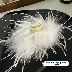 Detail view of large white ostrich feather hair claw clip, 11cm medium size dimensions