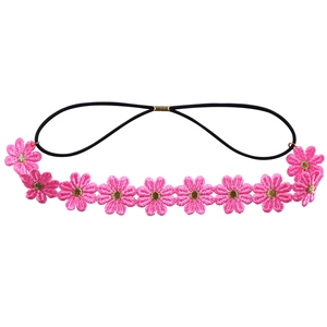 Detail of pink embroidered daisy hairband with golden center on black elastic strap