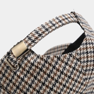 Detail of adjustable metal buckle and houndstooth pattern on the back of the baseball cap