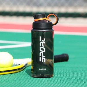 Dark green sports water bottle on a tennis court with high-quality plastic finish