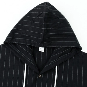 Close-up of neckline and drawstring hood on black striped linen shirt with size M label