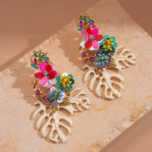 Detail of bohemian drop earrings with colorful sequins and white hollow leaf motifs