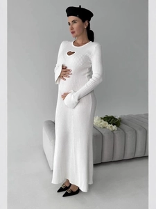 Elegant white knit maternity maxi dress with heart cutout design and long flared sleeves