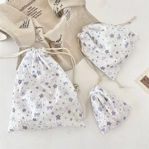 Detailed set of three white seersucker drawstring bags with purple bear patterns