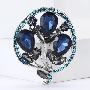 Elegant silver alloy brooch with three large blue water-drop crystals and teal rhinestones