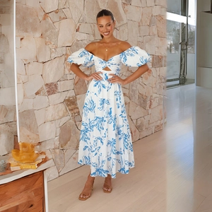 Detailed view of the blue floral print and puff sleeves on a white off-shoulder summer dress