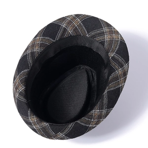 Detailed interior of vintage plaid fedora hat with black sweatband and lining
