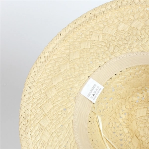 Detail shot of woven paper straw texture and internal sweatband on the Panama hat