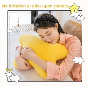Detailed texture of a soft yellow star-shaped plush pillow used in a home setting