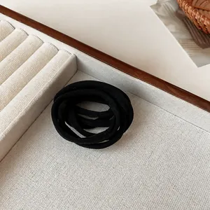 Minimalist elastic black hair bands set on a display card for elegant ponytail styling