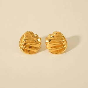 Macro view of 18k gold stainless steel earrings showing a spiral textured shell design