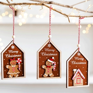 Set of 3 Christmas felt gingerbread man and house ornaments hanging on a festive tree